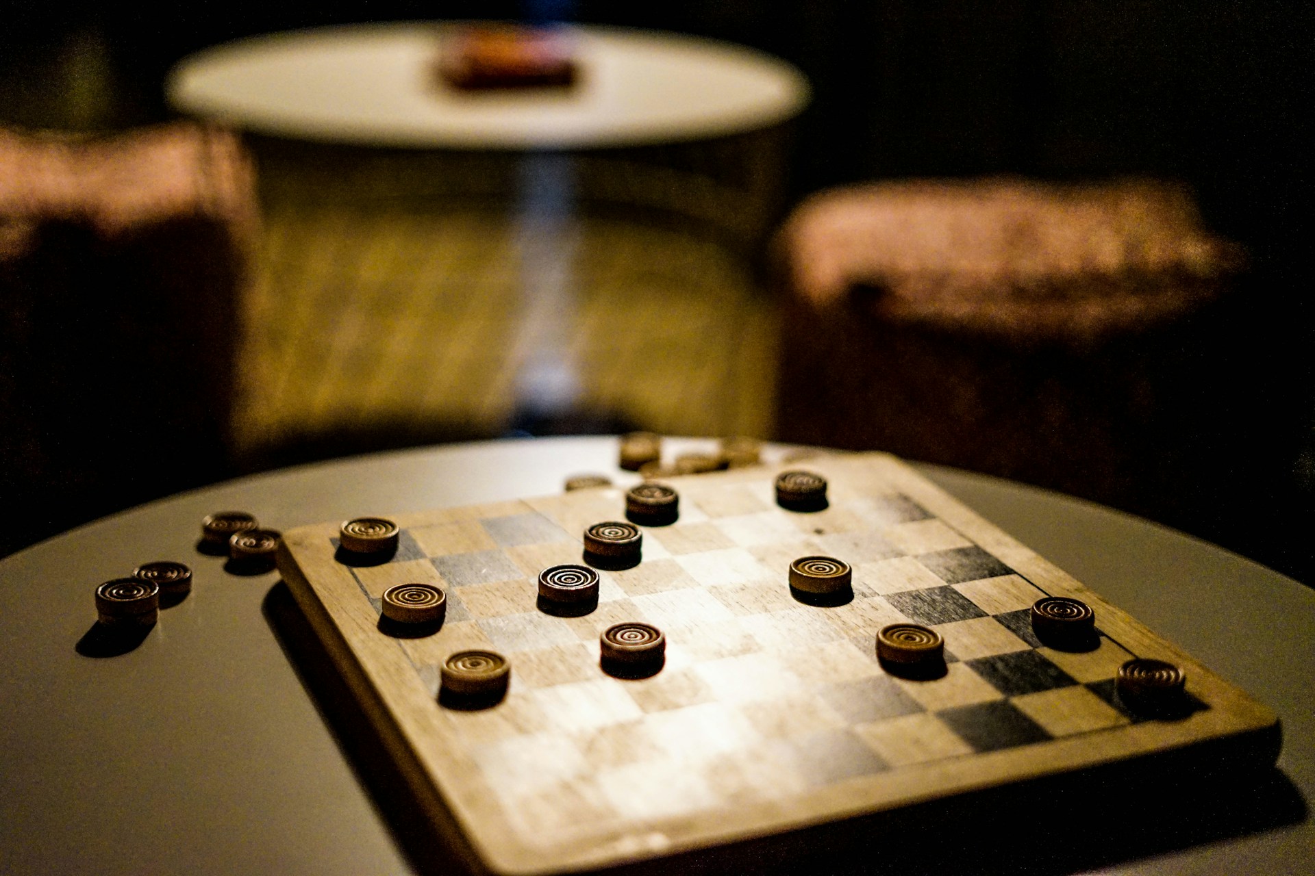 A checkers board part-way through a game